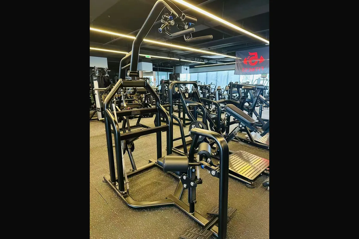 Compact strength training area with commercial gym machines