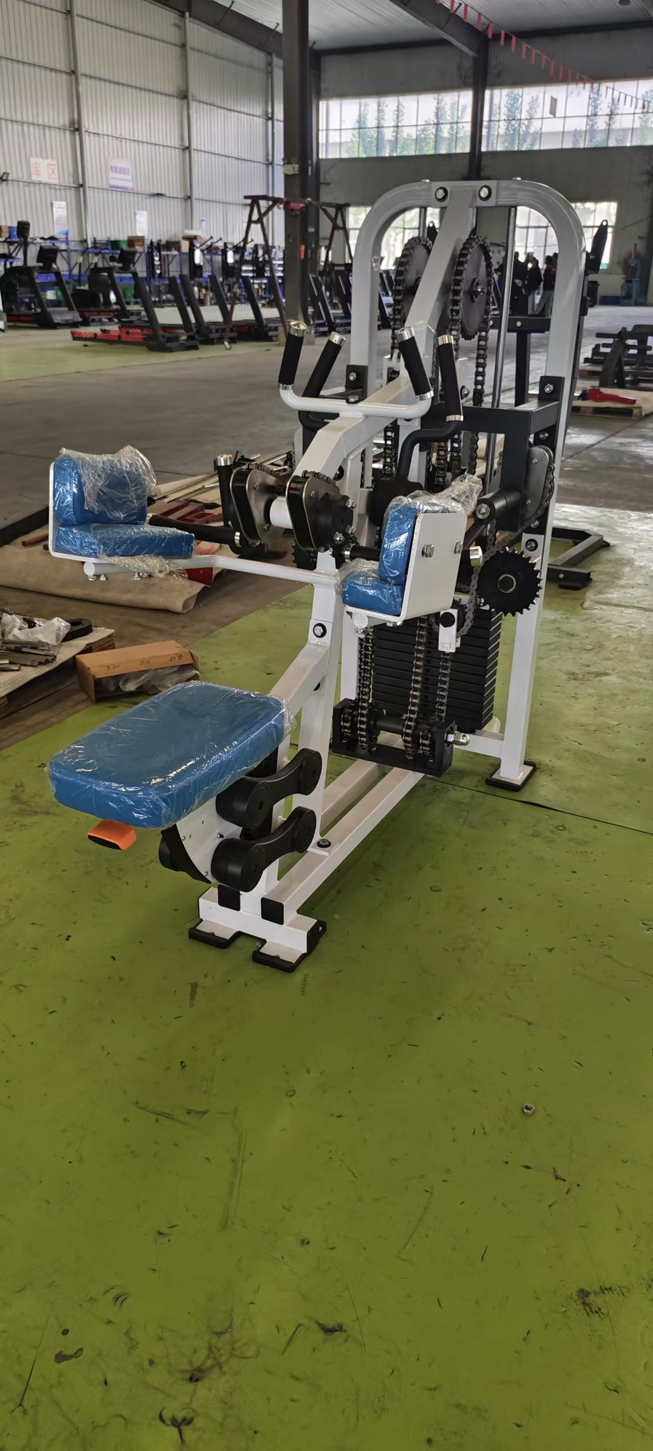 Side view of chain drive wrist and forearm grip trainer in factory area